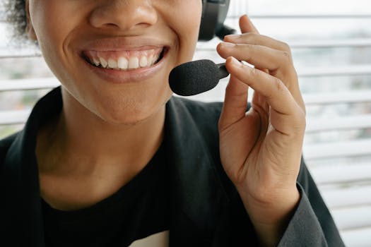 Close Up Photo of a Smiling Woman Holding Microphone